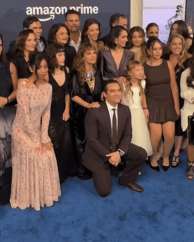 Group Posing On Blue Carpet With Amazon Prime Background GIF