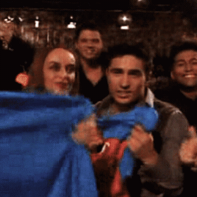 Group Posing With Blue Cloth GIF