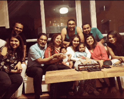 Group Posing With Cake GIF