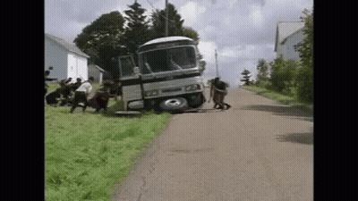 Group Pushing Bus Crashed Into Grassy Hill GIF