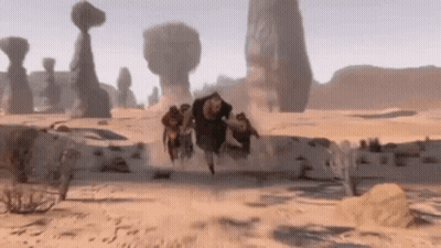 Group Running Through Desert With Rocks GIF