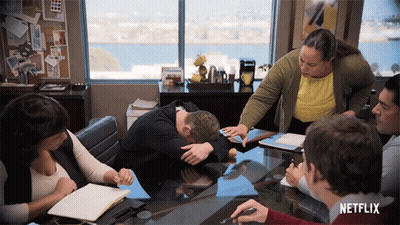 Group Sitting Around Table With Netflix Logo GIF