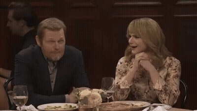 Group Sitting Around Table With Wine And Plates GIF