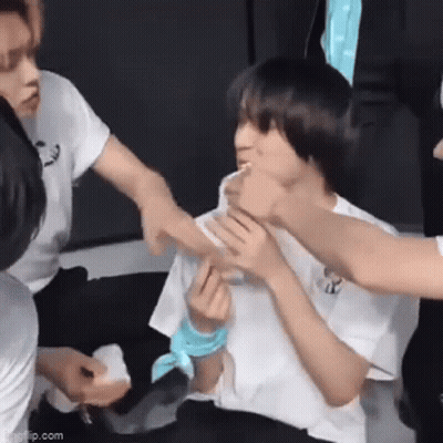 Group Sitting Around Young Man With Bandage GIF
