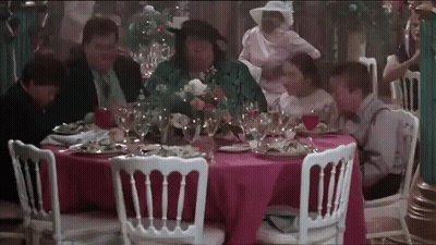 Group Sitting At Pink Tablecloth With Wine GIF