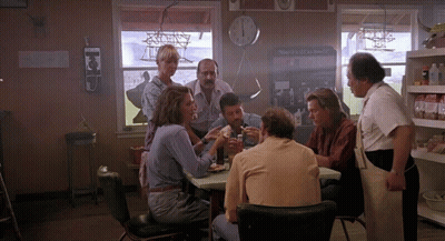 Group Sitting At Table In Front Of Clock Saying The Valley School GIF