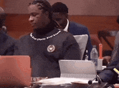 Group Sitting At Table With Laptops And Water GIF