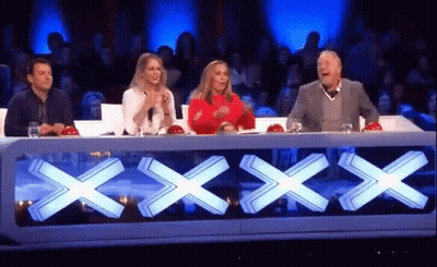 Group Sitting At Table With Large X GIF
