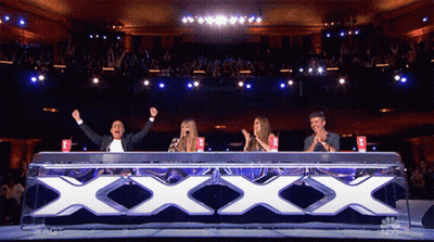 Group Sitting At Table With Large XXX GIF