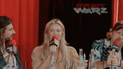 Group Sitting At Table With Microphones And Water GIF