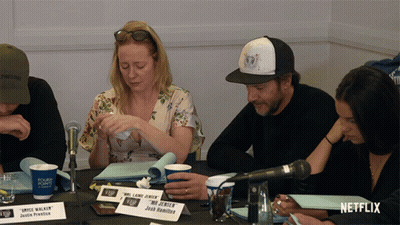 Group Sitting At Table With Netflix Logo GIF