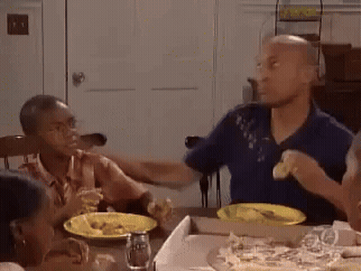 Group Sitting At Table With Pizza GIF