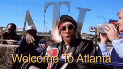 Group Sitting Before Welcome To Atlanta Sign GIF