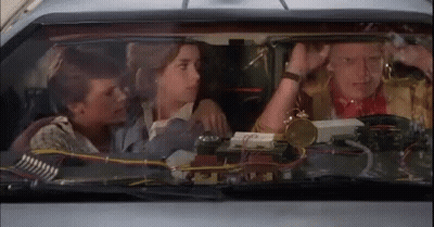 Group Sitting In Car With Clock GIF