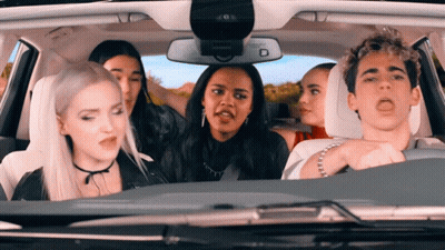 Group Sitting In Car With Rear View Mirror Letter D GIF