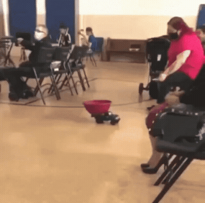 Group Sitting In Chairs With Stroller GIF