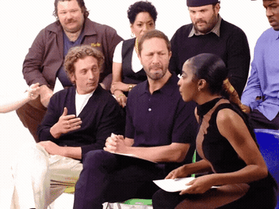 Group Sitting In Circle With Man Wearing York Jacket GIF