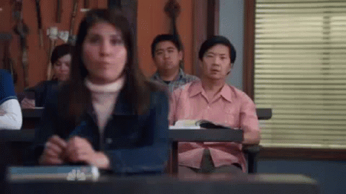 Group Sitting In Classroom With Hands Folded GIF