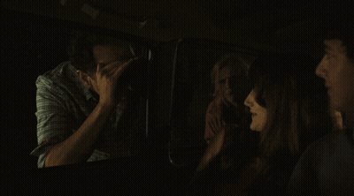 Group Sitting In Dark Room One Covering Face GIF