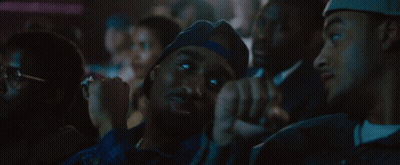 Group Sitting In Dark Room With Hat Saying La GIF