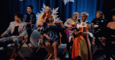 Group Sitting in Front of Blue Curtain With Snowflakes