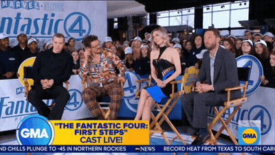 Group Sitting In Front Of Fantastic Four Sign GIF
