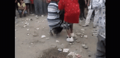 Group Sitting In Front Of Flower-Covered Coffin GIF