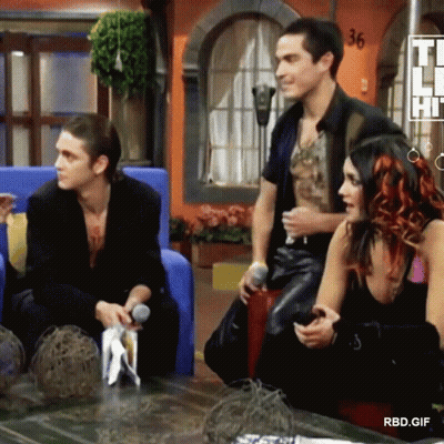 Group Sitting In Front Of RBD Sign GIF