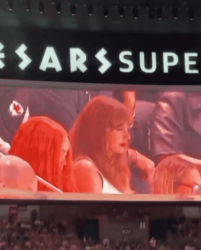 Group Sitting In Front Of Sarssupe Sign GIF