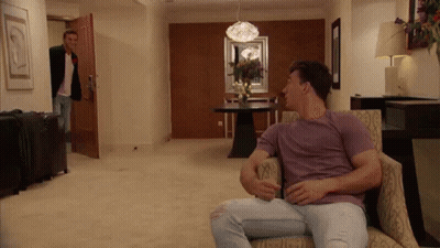 Group Sitting In Front Of Sign Saying Even They Were Weirded TF Out GIF