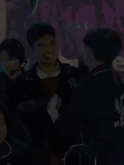 Group Sitting In Front Of Sign Saying We GIF