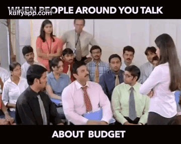 Group Sitting In Room With Woman Standing GIF