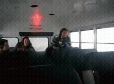 Group Sitting On Bus With Red Ceiling Light GIF