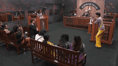 Group Sitting On Courtroom Benches With Malayalam Sign GIF