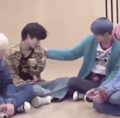 Group Sitting On Floor Petting Head GIF