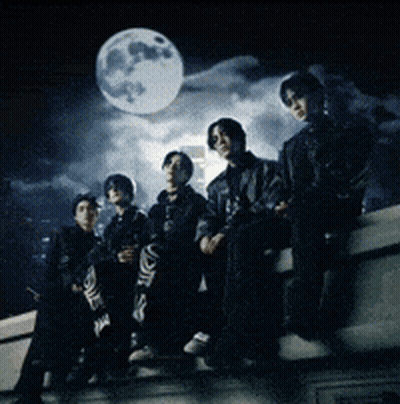 Group Sitting On Ledge With Full Moon GIF