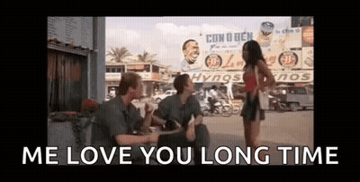 Group Sitting On Sidewalk Talking With Woman Standing GIF