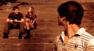 Group Sitting On Stairs With Brand New Sign GIF
