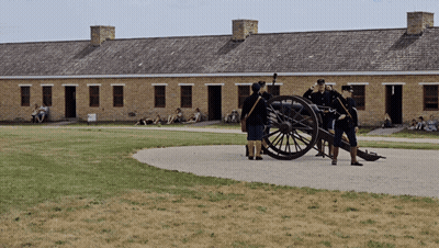 Group Standing Around Cannon GIF
