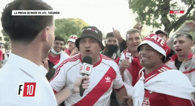 Group Standing Around Man Holding Microphone GIF