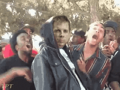 Group Standing Around Man In Hoodie GIF