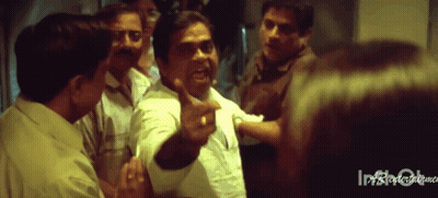 Group Standing Around Man Pointing GIF