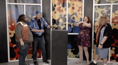 Group Standing Around Podium With Woman Screaming GIF