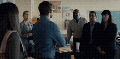 Group Standing Around Table GIF