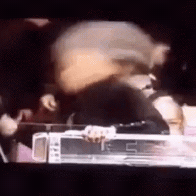 Group Standing Around Table In Dark Room GIF