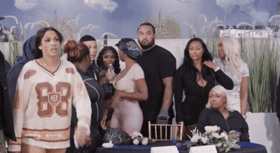 Group Standing Around Table With Jersey Number 83 GIF