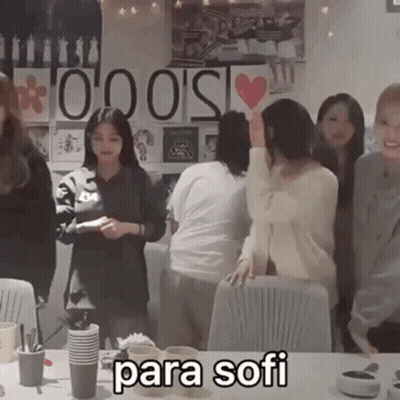 Group Standing Around Table With Para Sofi GIF
