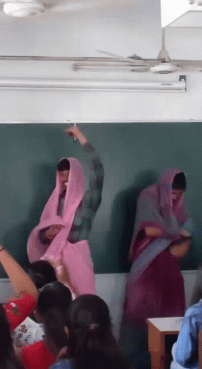 Group Standing At Blackboard With Pink Veil GIF