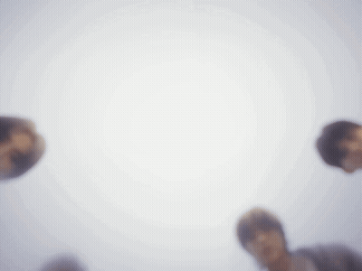 Group Standing In Circle Looking Up At Camera GIF