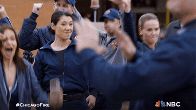Group Standing In Circle With Chicago Fire Logo GIF